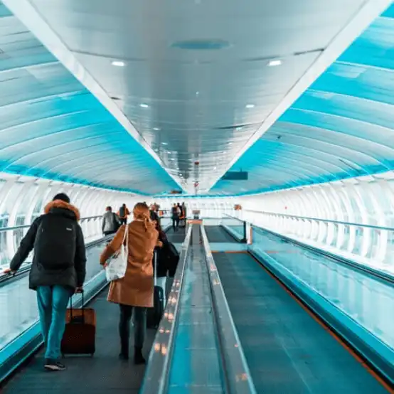 Manchester Airport, Airport walkway, ,airport,england,manchester,walkway,terminals,abstract,people,travel,architecture,transportation,blue,moving,transport,windows,lights,tunnel,sidewalk,transit,escalator