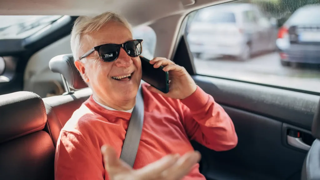 Happy senior enjoying a safe and comfortable taxi ride